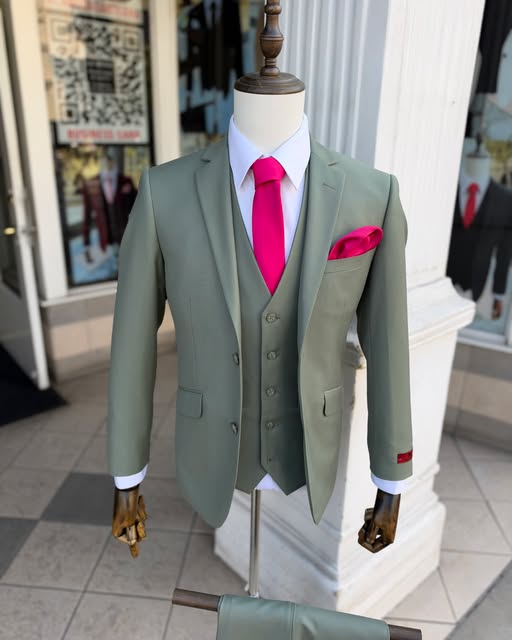 Sage three-piece suit with a pink tie