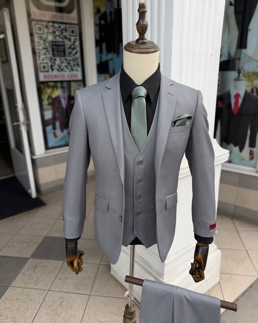 Silver-grey three-piece suit with a sage tie