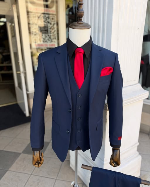 Navy three-piece suit with a red tie