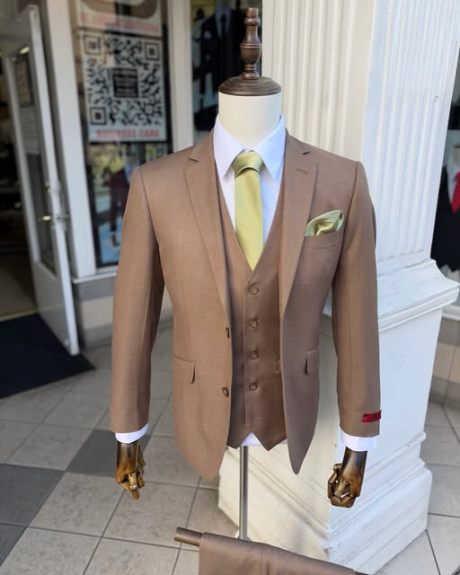 Camel three-piece suit with a gold tie