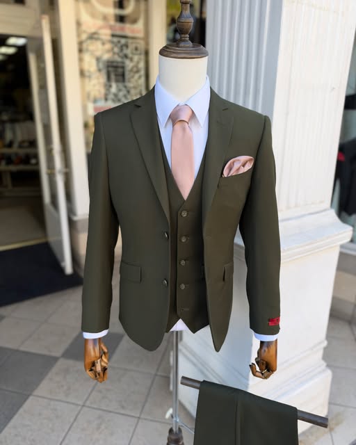 Olive three-piece suit with a blush tie