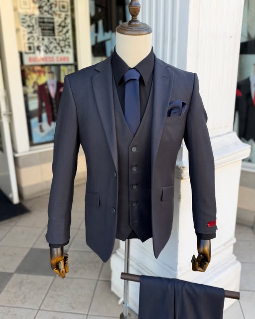 Charcoal three-piece suit with a navy tie
